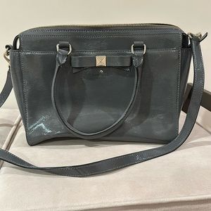 Kate Spade satchel with zipper and front pocket.